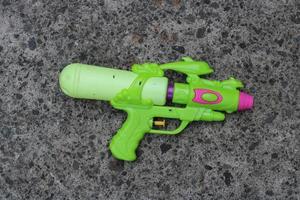 Photo of the green toy gun on the ground