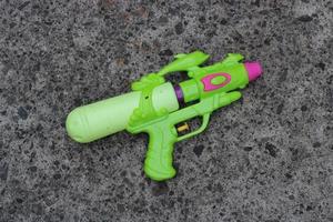 Photo of the green toy gun on the ground