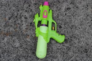 Photo of the green toy gun on the ground