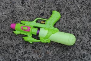 Photo of the green toy gun on the ground