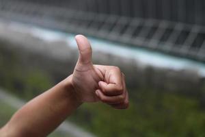 photo of hand waving outside the street