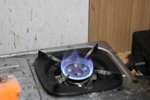 photo of gas stove lighting blue flame