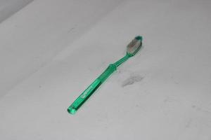 photo of a light green toothbrush