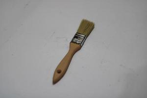 photo of a yellow brush made of wood with a white background