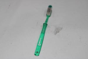 photo of a light green toothbrush