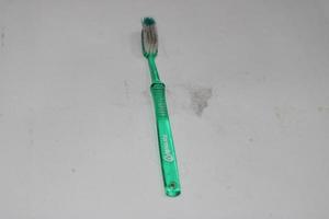 photo of a light green toothbrush