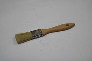 photo of a yellow brush made of wood with a white background