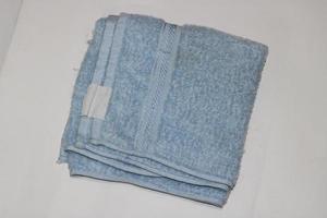 Photo of a light blue towel on a white background