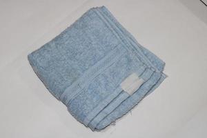 Photo of a light blue towel on a white background