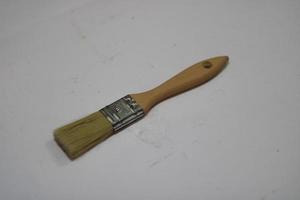 photo of a yellow brush made of wood with a white background