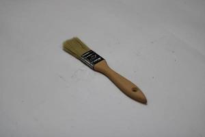 photo of a yellow brush made of wood with a white background