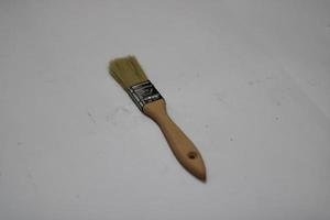 photo of a yellow brush made of wood with a white background