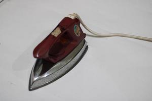 photo of an old silver red iron