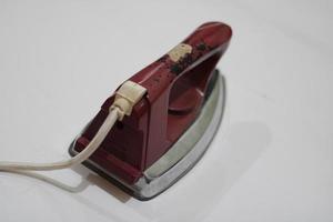 photo of an old silver red iron