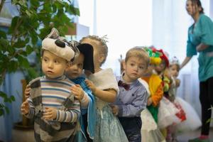 Two year old children from kindergarten on holiday. Build kids at a children's party. photo