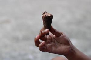 photo of chocolate ice cream in hand