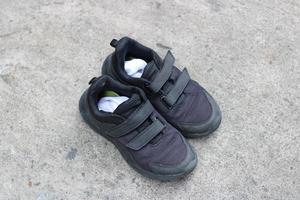 photo of black shoes worn on the street