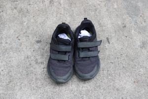 photo of black shoes worn on the street