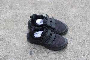 photo of black shoes worn on the street