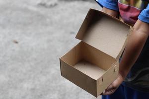 empty brown cardboard photo held in hand