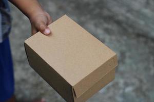 empty brown cardboard photo held in hand