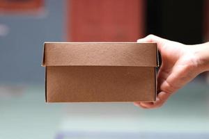 empty brown cardboard photo held in hand