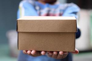 empty brown cardboard photo held in hand