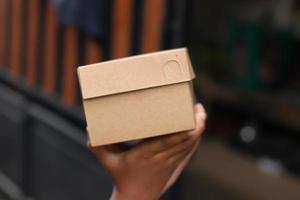 empty brown cardboard photo held in hand