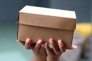 empty brown cardboard photo held in hand