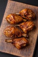 Delicious grilled chicken legs with spices and herbs in teriyaki sauce photo