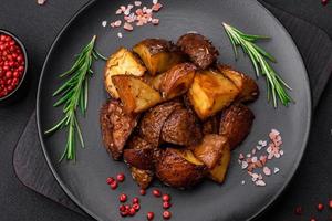 Delicious potatoes baked in their skins with rosemary and spices photo