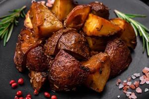 Delicious potatoes baked in their skins with rosemary and spices photo