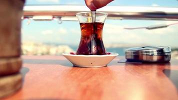 Drinking turkish tea in a cafe, drinking turkish tea in Istanbul with the view of Istanbul, selective focus, istanbul Turkey video
