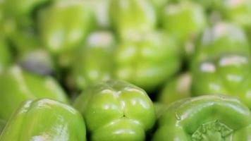 Vegetable and fruit in greengrocer, fresh green peppers on the grocery shelf, selective focus video