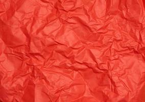 Crumpled red paper sheet, paper texture. Background for designers photo