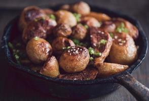 Fried potatoes in old pan photo