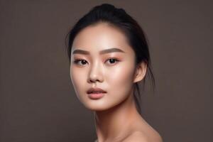 Studio portrait of an Asian girl with long black hair. Gray background. photo