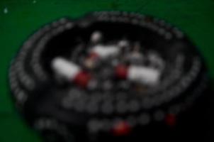 Abstract and blurry background of an ashtray and cigarettes. photo