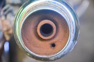 Close-up picture of dirty engine exhaust hole of motorbike. photo