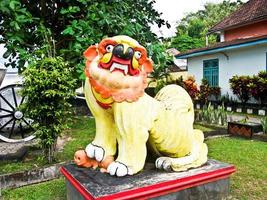 a yellow statue or lion dance in a park photo