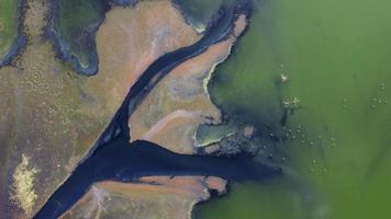 Aerial top down view dark water pollution at the pond video