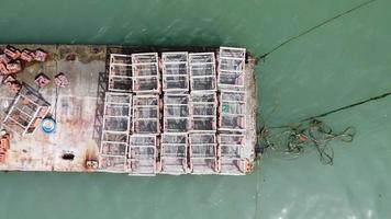 Aerial ascending look down crab trap at dock video