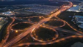 Aerial view light trail Lucky Clover shape Highway Interchange in night video