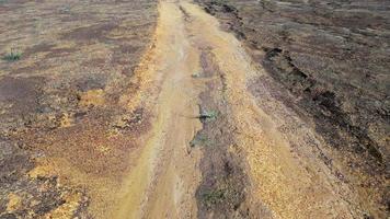 move forward look down red clay soil under hot day video