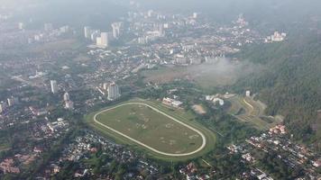 Aerial view Penang Turf Club in misty day video