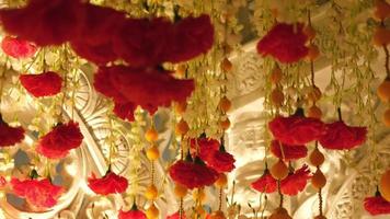 Tilt down the fake flower decoration in Hindu festival video