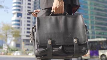 Businessman holding a business briefcase. Businessman standing on the street with his briefcase. video