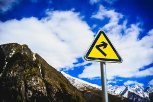 Traffic sign on the high mountain road photo