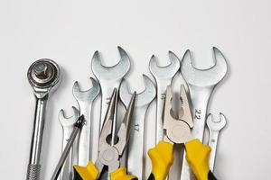 Set of tools for repair in a case on a white background. Assorted work or construction tools. Wrenches, Pliers, screwdriver. Top view photo