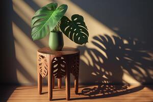 Wooden table with beautiful sunlit green tropical plant leaves and shadows on beige wall. photo